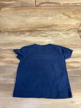 Back view of Carter's navy 18m dinosaur T-shirt showcasing plain back and short sleeves, laid flat on wood floor