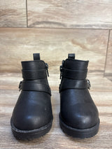 Black toddler boots with side zippers and buckle straps, kids footwear on wood floor