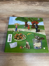Back cover of What If Everybody Did That? hardcover book showcasing illustrated park scene with girl, raccoon in a trash can labeled Please don't litter, flowers on a wood table