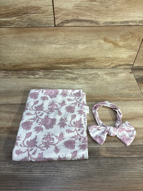Flat lay of Toby floral 2-piece headband and wrap set showing pink floral print on white fabric on a wood tabletop