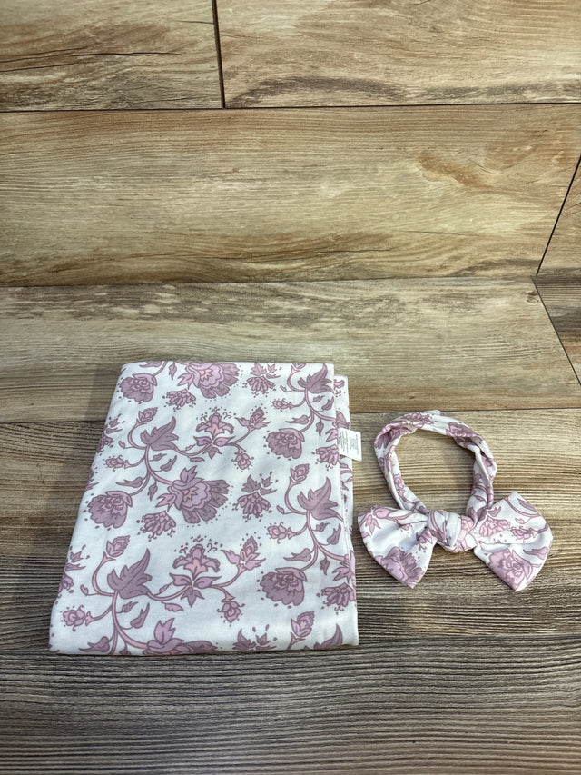 Flat lay of Toby floral 2-piece headband and wrap set showing pink floral print on white fabric on a wood tabletop