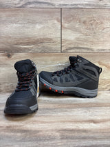 Black and gray kids hiking boots with red accents on wood floor