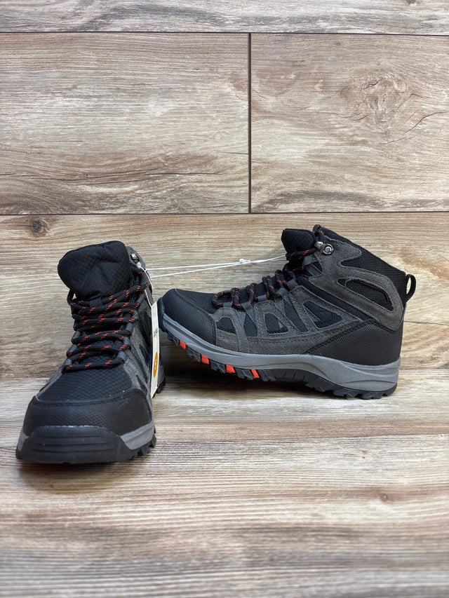 Black and gray kids hiking boots with red accents on wood floor