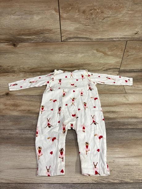 Front view of ivory ballerina-print henley coverall with long sleeves and heart accents on a wood floor