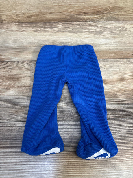 Blue baby waffle knit footed pants on wooden background