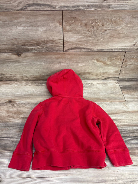 Back view of a red Baby Gap full-zip jacket in size 2T showcasing its hood and ribbed hem on a wood surface