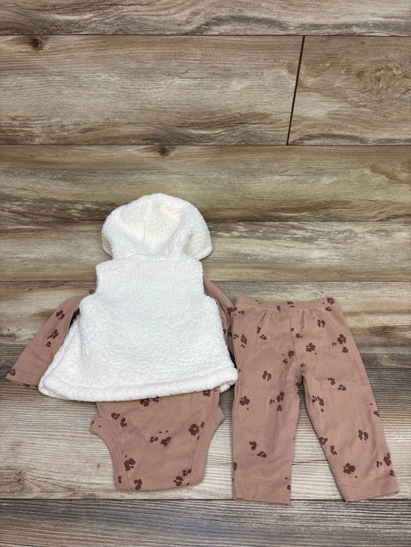 Top-down view of Child Of Mine 3-piece set with white sherpa hooded vest, patterned bodysuit and pants on wood
