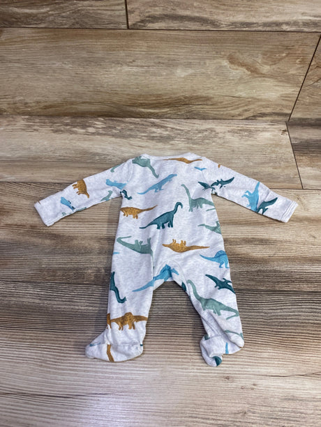 Top view of Child Of Mine grey preemie sleeper showcasing dinosaur print and footed legs on a wood floor