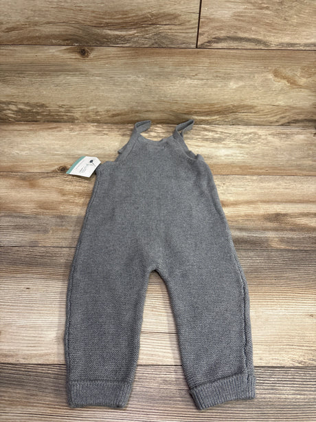 New grey knit overalls for babies by Me n Mommy To Be, displayed on a wooden background.