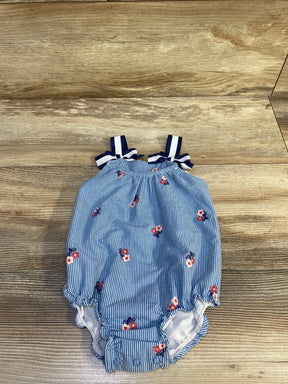 Top view of Baby Starters light-blue striped romper with pink floral print, navy bow straps and snap crotch on wood floor