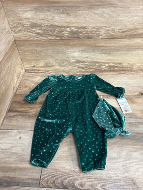 Green velvet polka dot baby jumpsuit with matching knot headband on wood floor