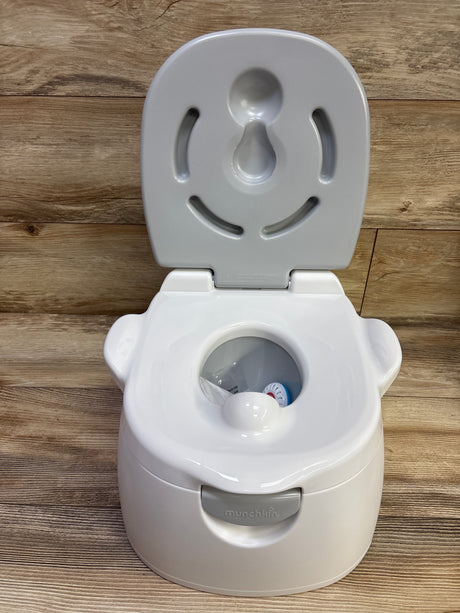 Front view of Munchkin Arm & Hammer Multi-Stage 3-in-1 Potty with open lid and gray front handle on wood-look flooring