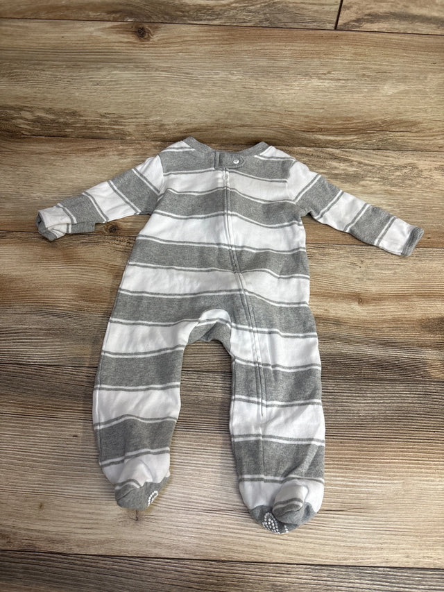 Gray and white striped long-sleeve baby footed onesie lying flat on wooden floor
