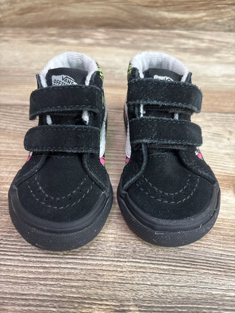 Front view of Vans SK8-Mid Reissue V Trippy Drip sneakers in black, showing double hook-and-loop straps on a wood floor
