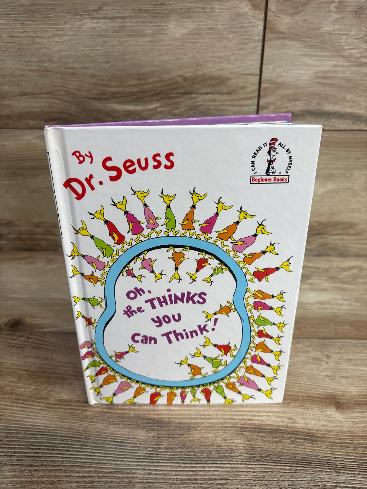 Dr. Seuss children's book Oh, the Thinks You Can Think! on wood surface, featured in kids resale store