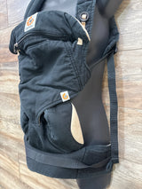 Side view of Ergobaby Four Position 360 carrier, black with tan lining, showing zippered hood pocket, padded waist belt and adjustable shoulder straps on a mannequin