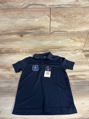 Navy blue IZOD boys polo shirt with moisture-wicking tag and $24 price tag on wood floor