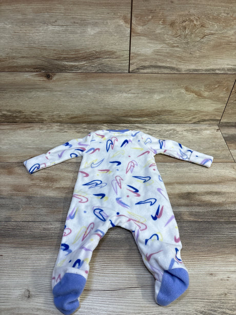 Flat lay of white Nike blanket sleeper (size 3M) with pastel multicolor swoosh print, long sleeves and footed design on wood background