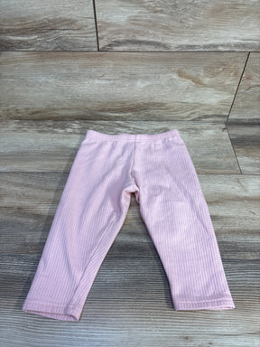Front flat lay of Carter's pink ribbed toddler leggings 24m on wood background showing ribbed texture and elastic waistband