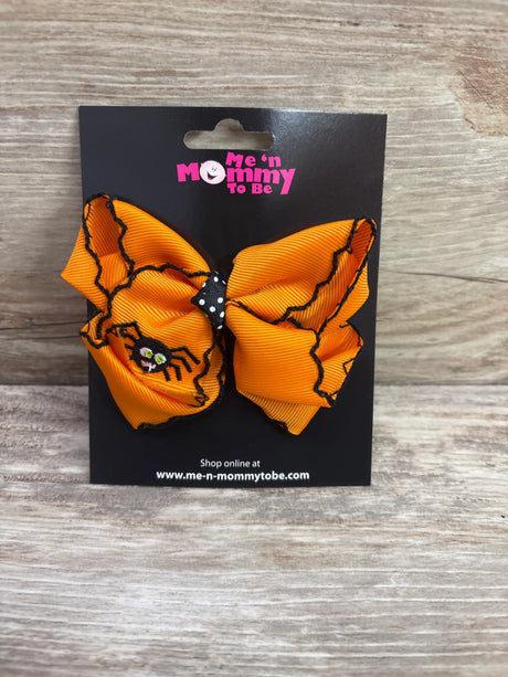Large orange embroidered spider hair bow by Me n Mommy To Be on a black display card.