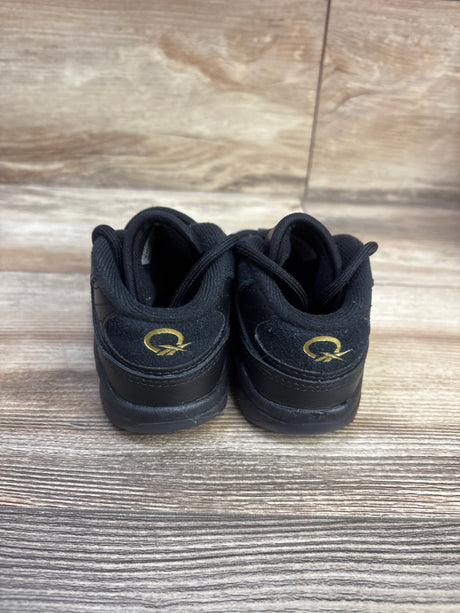 Rear view of Reebok Question Mid Toddler Lux sneakers showcasing gold heel logos with a wood floor background