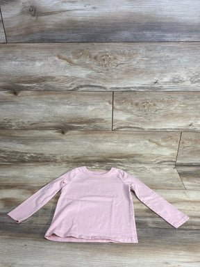 Front flat lay of Jumping Beans 3T long-sleeve pink toddler shirt showcasing crew neck and straight hem on wooden floor background