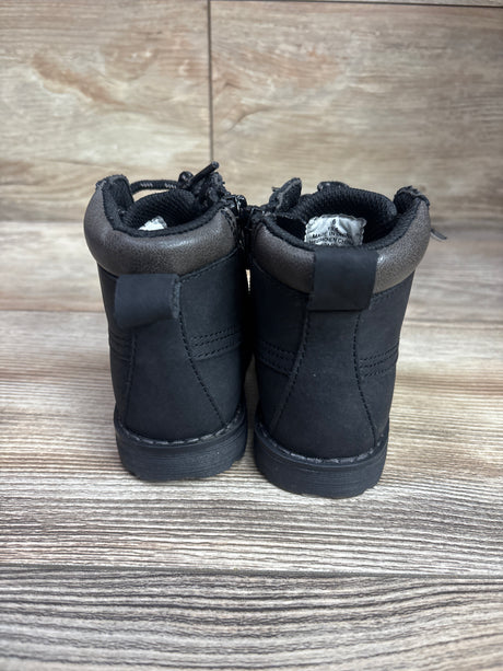 Rear view of black Old Navy combat zip-up boots, size 6C, showcasing padded collars and stitched panels on a wood-grain surface