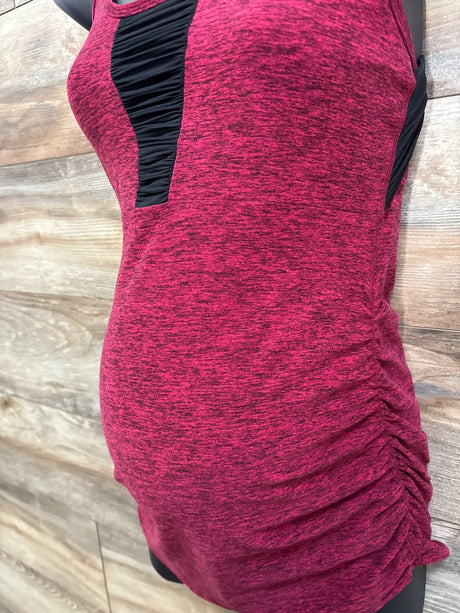 Side of maternity racerback tank top in spacedye red with ruched side for belly and black front inset on wood panel
