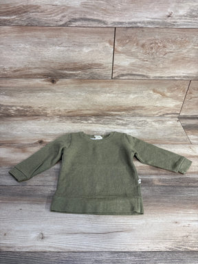 olive green long sleeve toddler sweatshirt on wood plank floor background