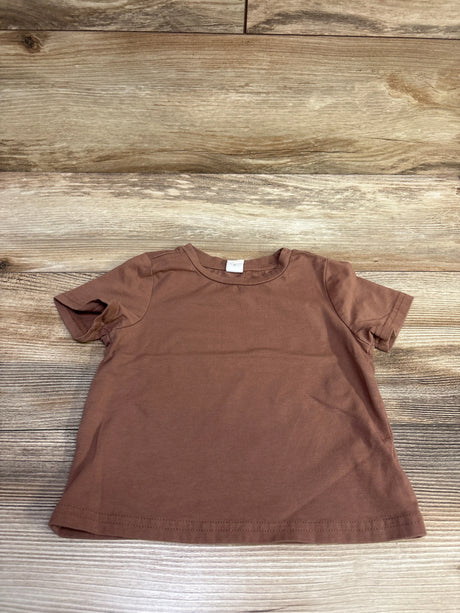 Front view of a brown Shein shirt for ages 12 to 18 months showcasing short sleeves and crew neck, laid flat on wood
