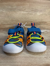 Colorful kids sneakers with blue, orange, and yellow accents on wood background