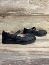 Black girls' Mary Jane dress shoes with hook-and-loop straps on wood background