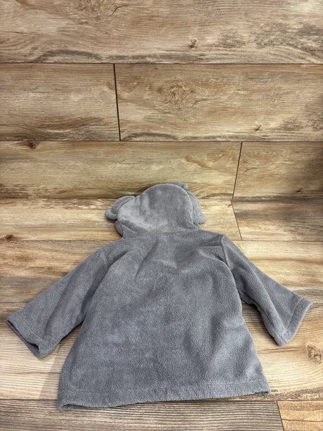Back view of the gray hooded elephant bath robe showcasing its elephant-ear hood and long sleeves on a wood floor