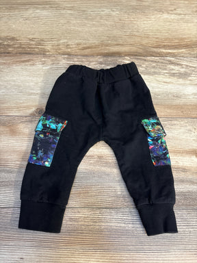 Black toddler jogger pants with colorful cargo pockets on wooden background