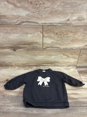 Black toddler sweatshirt with white bow and 'ma chérie' text on wooden floor