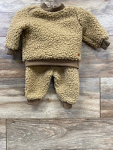 Tan sherpa baby outfit set with long sleeve top and pants on wood background