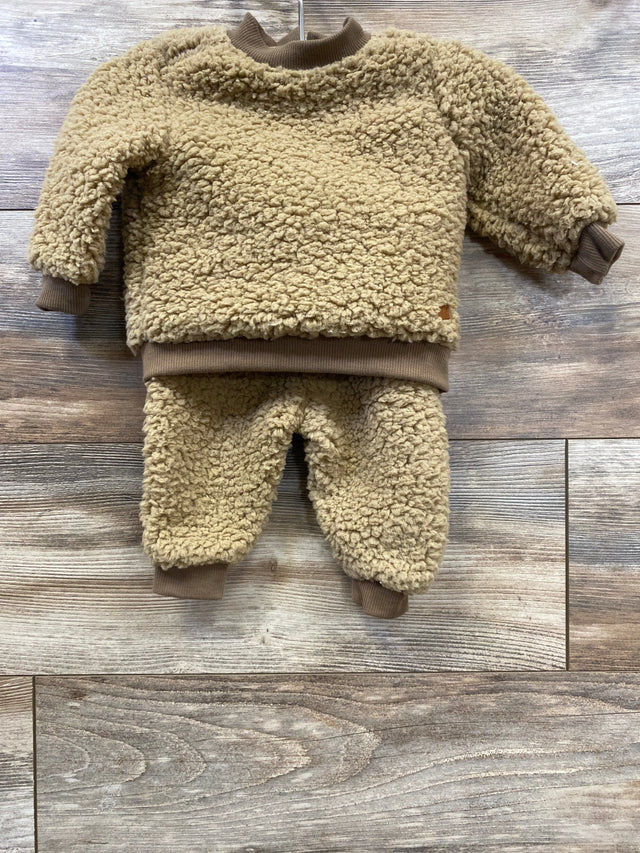 Tan sherpa baby outfit set with long sleeve top and pants on wood background