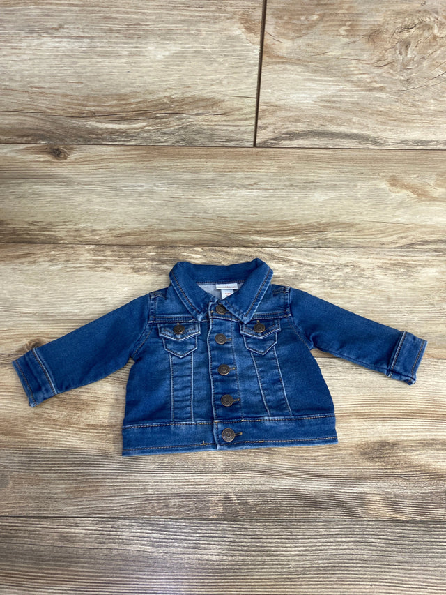 Toddler blue denim jacket with button-up front and chest pockets on wooden floor