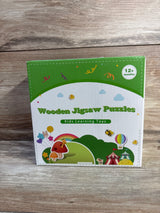 Front view of wooden jigsaw puzzles box showcasing colorful animal illustrations and "12+ months" age label on wooden tabletop