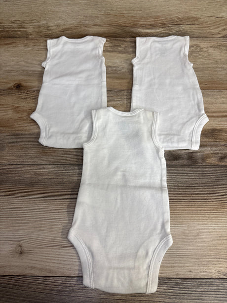 Three plain white sleeveless baby bodysuits on wood background, gently used kids clothes