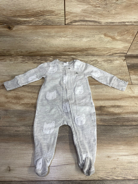 Light gray baby onesie with white bear patches, full-length zipper, against wooden floor