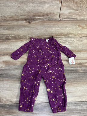 Purple long sleeve baby romper with gold star print on wood background