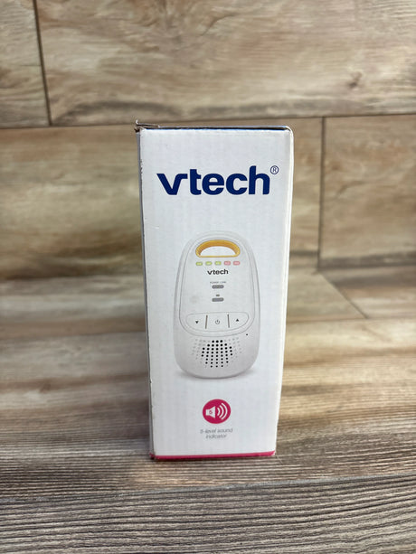 Front of VTech DM111 monitor box showing VTech logo and unit image with five-level sound indicator on wood