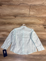 Light blue striped kids button-down shirt on hanger, IZOD brand tag visible, laid on wood floor