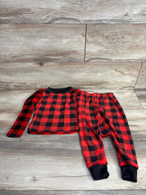 Red and black plaid long sleeve toddler pajama set with black cuffs on wood floor
