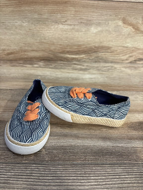 Children's casual slip-on shoes with blue wave pattern, orange laces, and woven detailing on the sole