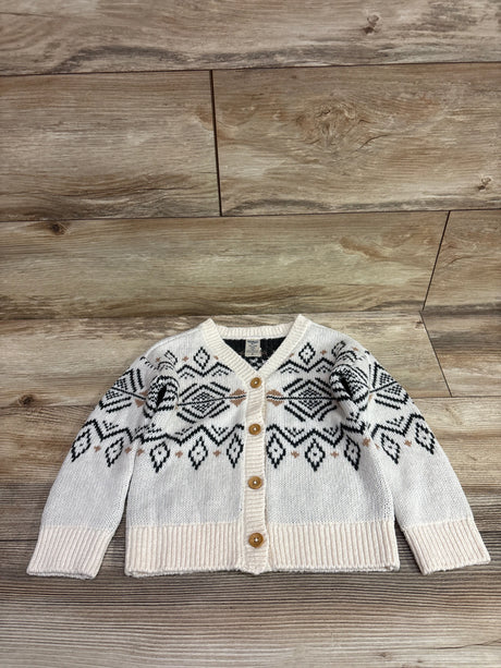 Ivory Fair Isle button-up knit cardigan sweater for toddlers on a wooden background.