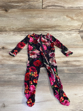 Front flat-lay of black floral baby footie by Alice + Olivia x Posh P showing diagonal zipper and footed legs on light wood background