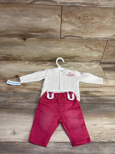 Carter's newborn 2-piece set featuring an ivory knit sweater and red pants on a hanger.