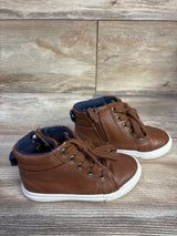 Angled view of brown Cat and Jack toddler high-top sneakers with side zipper and white sole on wood background